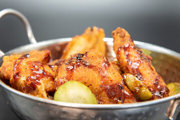 Bowl of hot chicken wings and drumsticks for a great spicy flavor.