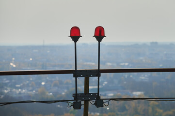 Red warning warning light with the light on, against the blue sky. explosive plant area. red lights...