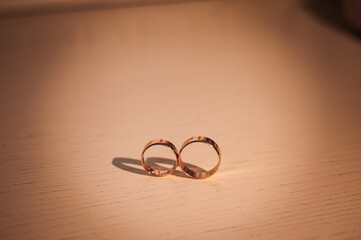 Gold wedding rings on the table. Wedding accessories
