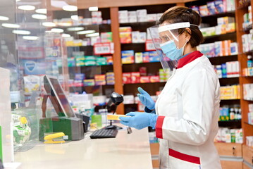 Naklejka na ściany i meble Pharmacist dispensing drugs in a pharmacy. 