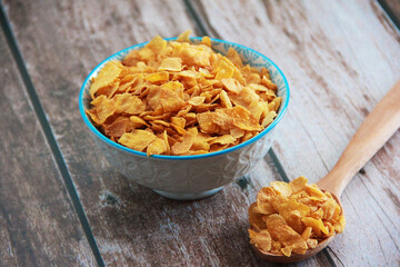 Breakfast with natural crunchy muesli and a wooden spoon