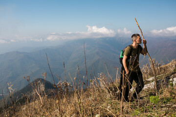 A guy with a backpack in the mountains.