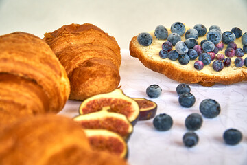 Blueberries and croissants are healthy foods. Fresh pastries for breakfast. Delicious vitamins. High quality photo
