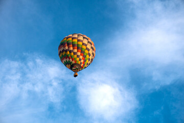 Hot air balloon on beautiful sky background. Balloon rises in height bottom view.