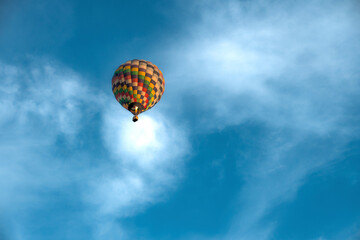 Fototapeta na wymiar Hot air balloon on beautiful sky background. Balloon rises in height bottom view.