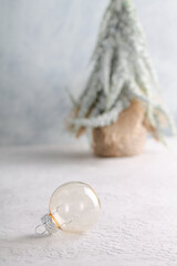 Winter background with a transparent glass ball. Christmas time.