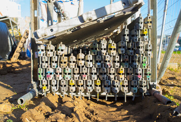 Unmounted scaffolding elements piled at construction site