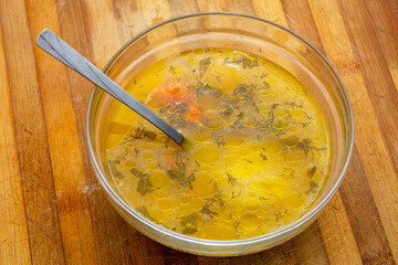 Close up on a chicken soup with vegetables