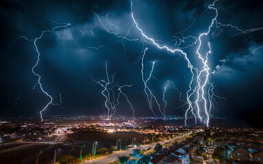 Lightning storm over cityi n blue light