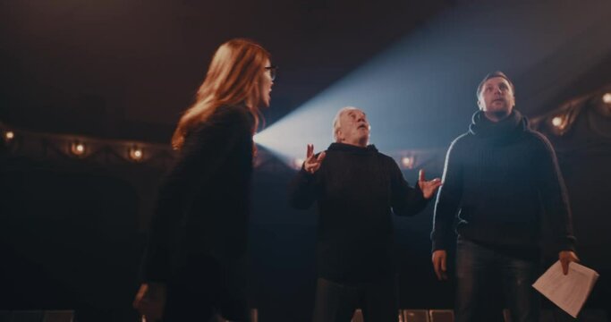 Man and woman acting out quarrel with director