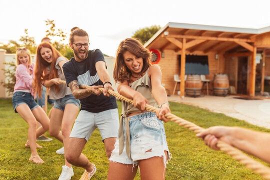 People playing tug of war while on team building trip