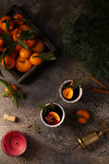 Mulled wine in ceramic glasses with tangerines,fresh rosemary,thyme,cinnamon and anise stars.Winter or Christmas hot drink.Top view.