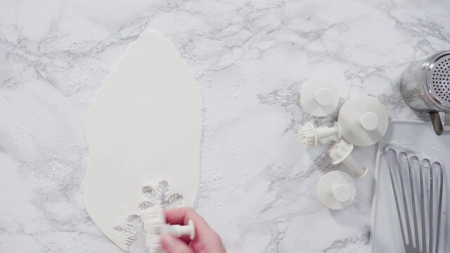 Flat lay. Step by step. Rolling our white fondant on a marble counter.