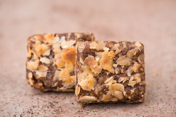 Confectioneries with nuts and chocolate, german christmas sweets, little cakes on a brown textured background, empty copy space for text