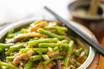 angle view fast food pork with eggplant and beans and bowl of soup horizontal composition