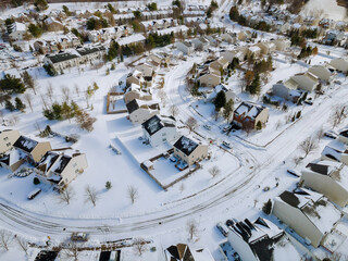 Aerial view of landscape top of the winter town residential houses with snow covered houses and roads.