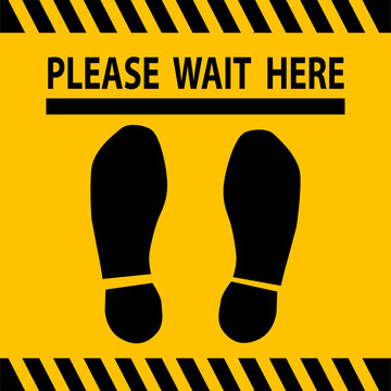 Please wait here sign, decal or sticker on the floor at a store checkout lane to enforce social distancing.