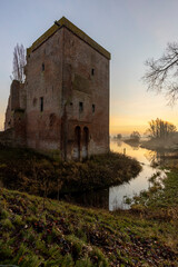 Remains of Nijenbeek castle in The Netherlands along the river IJssel at sunrise