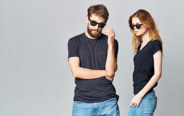 young couple in black t-shirts sunglasses studio romance communication elegant style