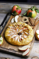 Top view of apple pie on wooden board. Apple galette is delicious and juicy.