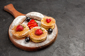 front view yummy pancakes with fruits and cakes on dark desk fruit sweet cake