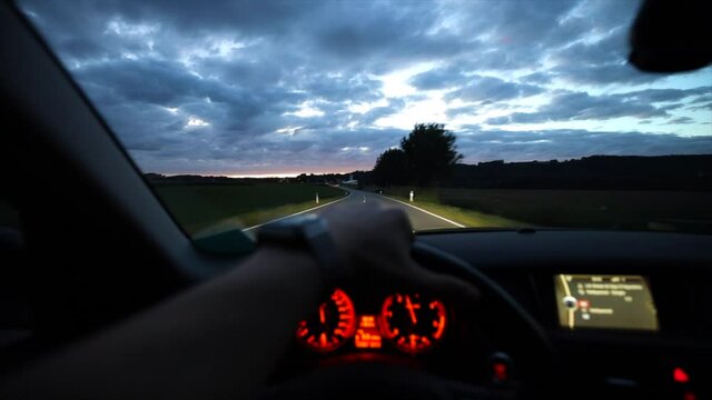 FPS car driving at dusk