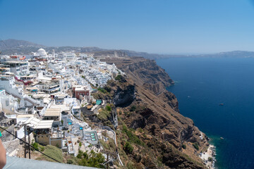 Fototapeta na wymiar Balconies and roof tops in the village of Oia, Santorini. Architecture and landscape of Greece. Amazing panoramic view.