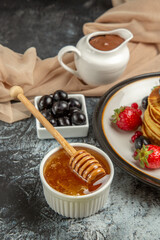 front view delicious pancakes with fruits and honey on light background fruit cake sweet
