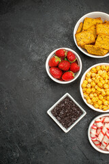 top view different eatings crisps fruits and candies on dark background tea sweet crisp photo