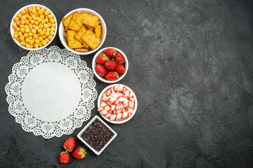 top view fresh strawberries with different snacks on dark background photo sweet cracker