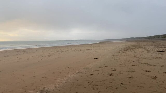 sunset beach storm beach camber sands in East Sussex, UK sand dunes pan to sunset low tide flat sandy beach 