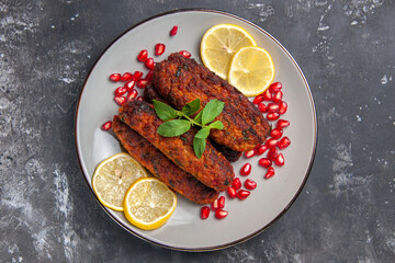 top view meat cutlets long formed with lemon slices on grey background meal photo dish