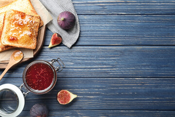 Flat lay composition with delicious fig jam on blue wooden table. Space for text