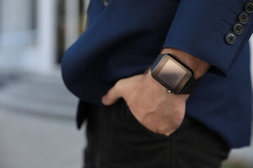 Man with smart watch outdoors, closeup view