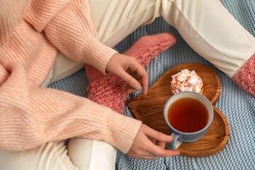 Fototapeta na wymiar Woman with tea and snack on plaid, above view