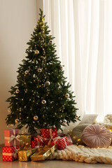 Beautiful Christmas tree and gift boxes in light room. Interior design
