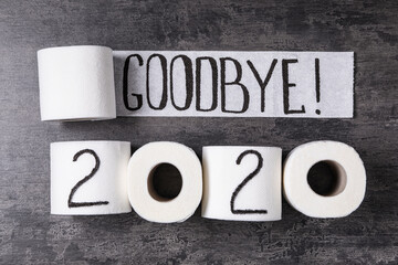 Text Goodbye 2020 made with toilet paper on grey stone background, flat lay