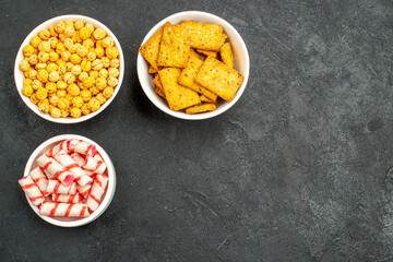 top view different candies with crisps on dark background sweet photo snack cracker