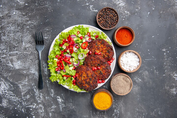 top view tasty meat cutlets with fresh salad on a grey background photo food dish meat