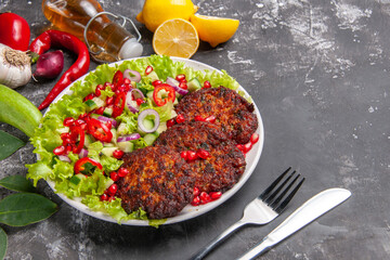 Fototapeta na wymiar front view delicious meat cutlets with fresh salad on grey floor meal photo food dish