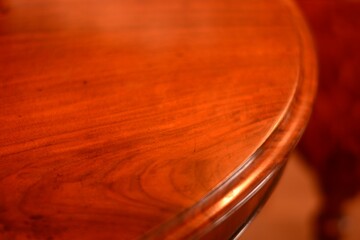 room of the antique walnut oval dining table. with defocused chair. This expensive furniture is made in England. texture background with copy space.