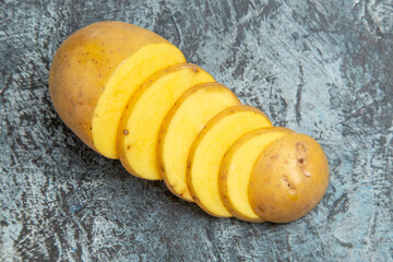 Top view of easy delicious unpeeled potato slices of gray background footage