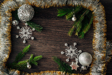 Christmas Tree Branches and Snowflakes on a Brown Background with Copy Space