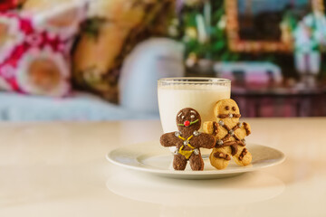 BDSM themed gingerbread cookies. fun looking cookies and a glass of milk. Sexy cookie with mouth ball and leather suit look designed in bsdm style.