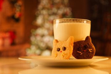 Cocoa and gingerbread cookies for New Year's Eve and Christmas themed. An image of a cat-like...