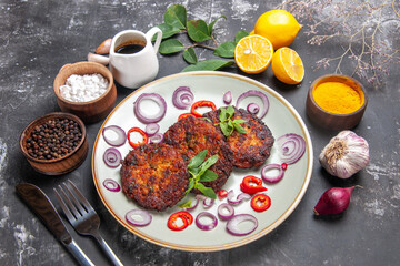 top view delicious cutlets with onion rings on the grey background dish meat meal cuisine