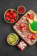 Fototapeta na wymiar top view yummy creamy cake with strawberries on dark background sweet sugar desserts tea