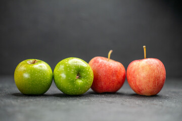 Side view of fresh red and green apples as apart of healthy life on dark background
