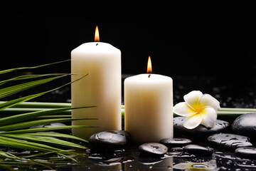 spa still life of with 
White frangipani and  two towel, green palm,zen black stones ,wet background
