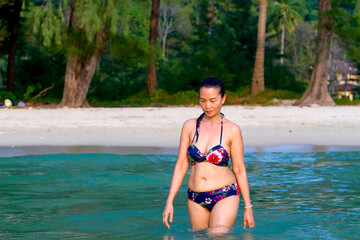 Obraz premium Woman walk in water with bikini